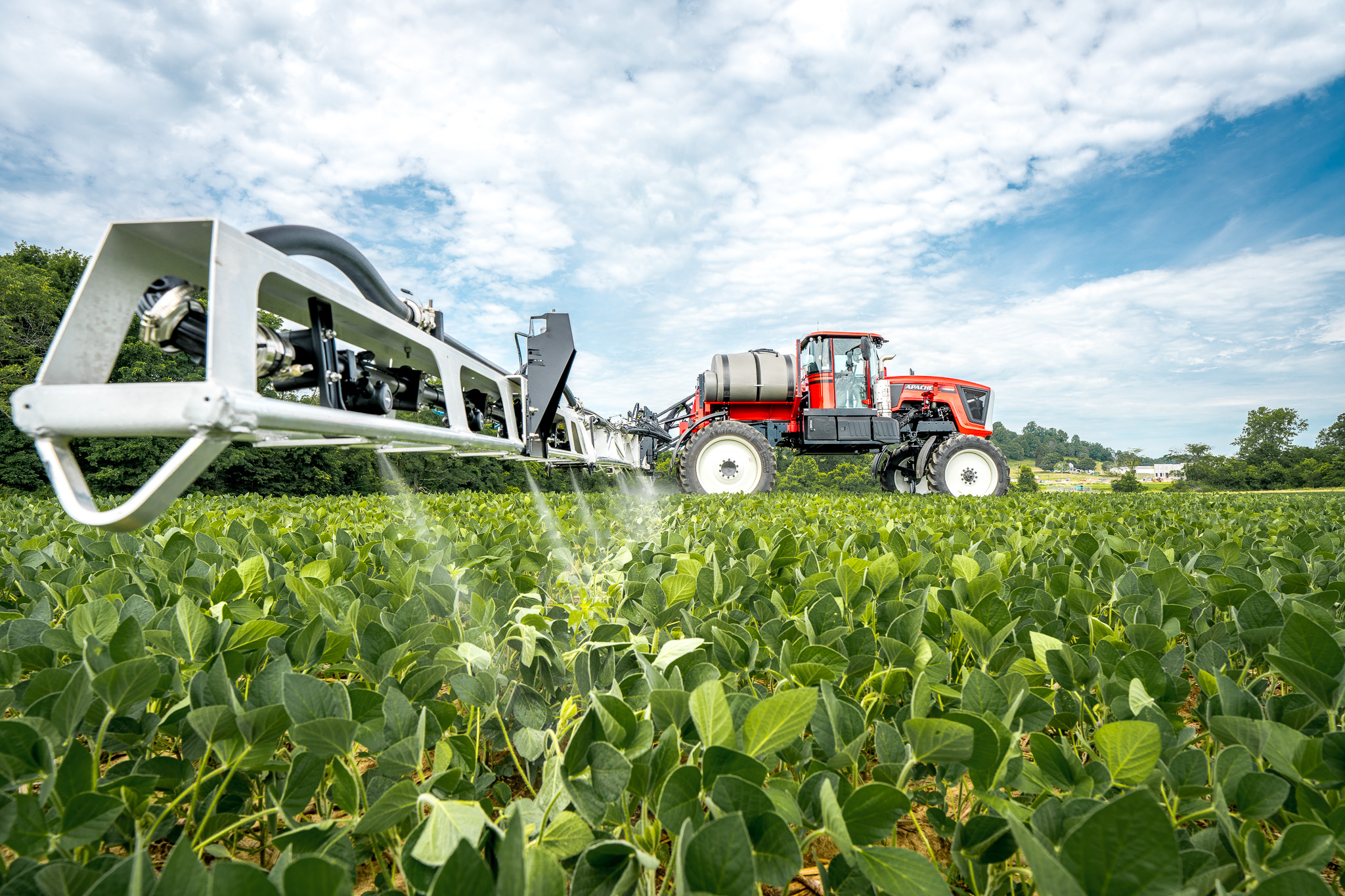 side view of apache sprayer in use in bean field